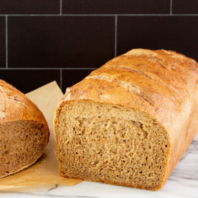 Best ever pumpernickel bread, a round loaf and sliced standard loaf