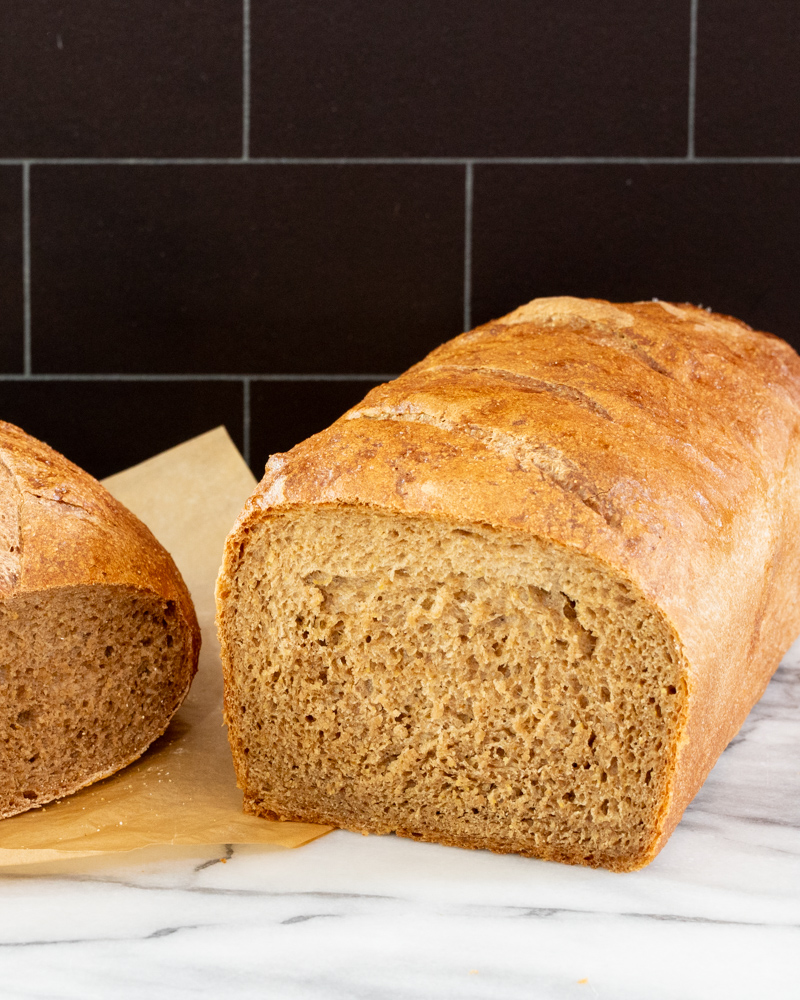 Best ever pumpernickel bread, a round loaf and sliced standard loaf