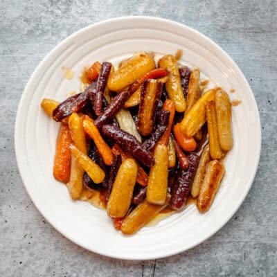 A plate of glazed roasted baby rainbow carrots.