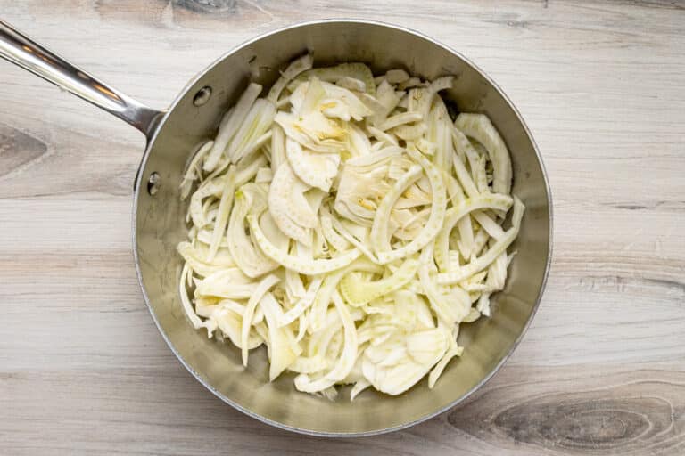 Sliced fennel in a sauté pan.