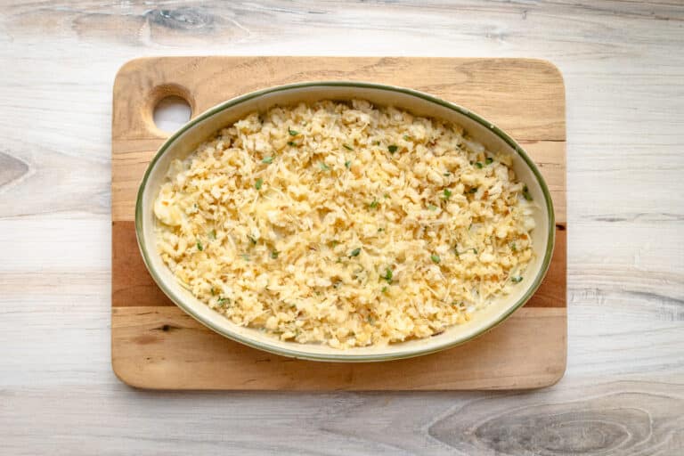 The baking dish with partially cooked fennel and cream, topped with breadcrumbs.