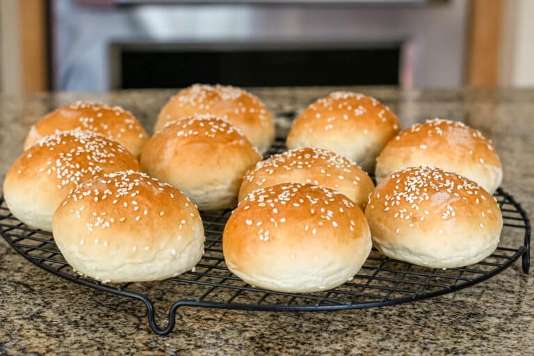 Homemade potato buns on a rack.