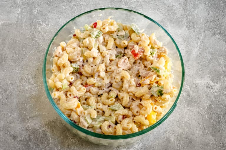 A bowl of classic tuna and macaroni salad with bell peppers, celery, and a simple mayonnaise dressing.