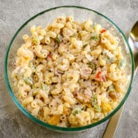A bowl of classic tuna and macaroni salad with bell peppers, celery, and a simple mayonnaise dressing.