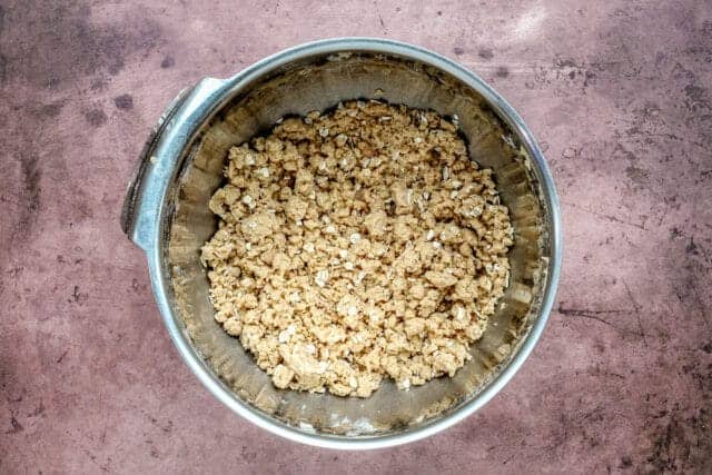 Air fryer apple crumble prep: crumb topping is prepared with flour, butter, brown sugar, and oats.