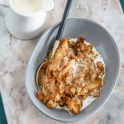 Fried apple dessert with crispy topping and milk.