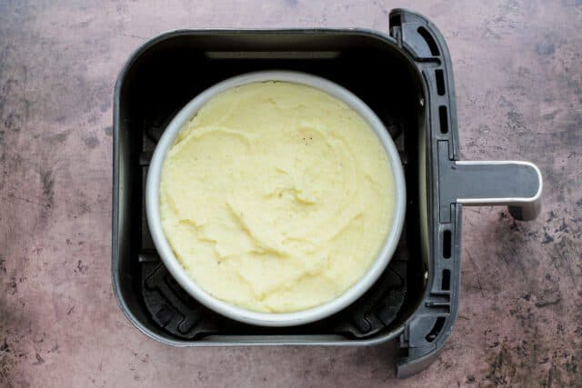 The cottage pie is topped with mashed potatoes and placed in the air fryer.
