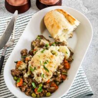 An air fryer cottage pie with a baguette slice on the side.