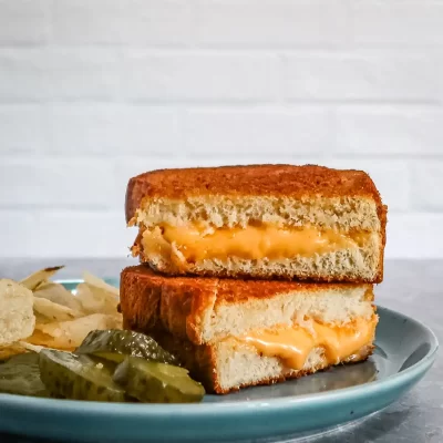 Deep-fried grilled cheese sandwich with melted cheese inside.