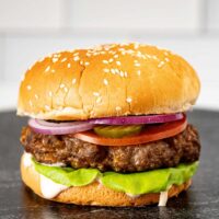 Air fryer hamburger in a bun with toppings.