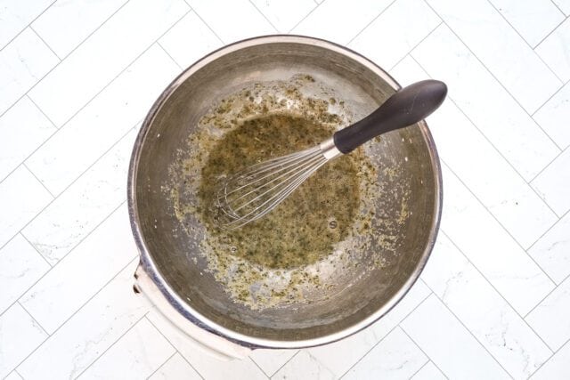 Melting butter in a saucepan with a whisk for cooking or baking.