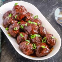 Tender glazed meatballs topped with chopped green onions.