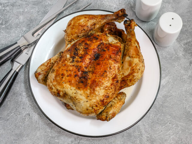 Air Fryer whole roasted chicken, perfectly cooked and golden brown, from Classic-Recipes.com.