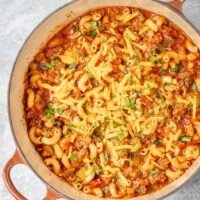 American style goulash in a Dutch oven, with cheese topping.