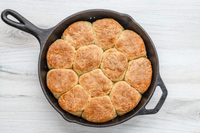 Golden-brown cooked chicken biscuits in cast iron skillet.