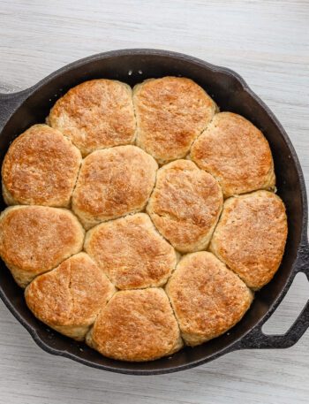 A skillet with fluffy baked angel biscuits.