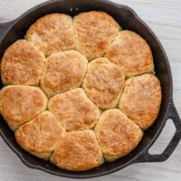 Buttermilk biscuits baked in a cast iron skillet.