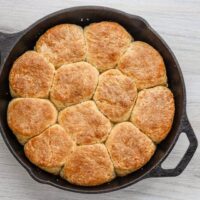 Freshly baked bread rolls in a cast iron skillet.