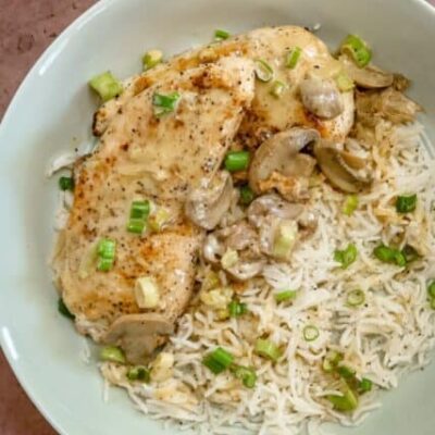 apple brandy chicken on a bed of rice with mushrooms and green onions