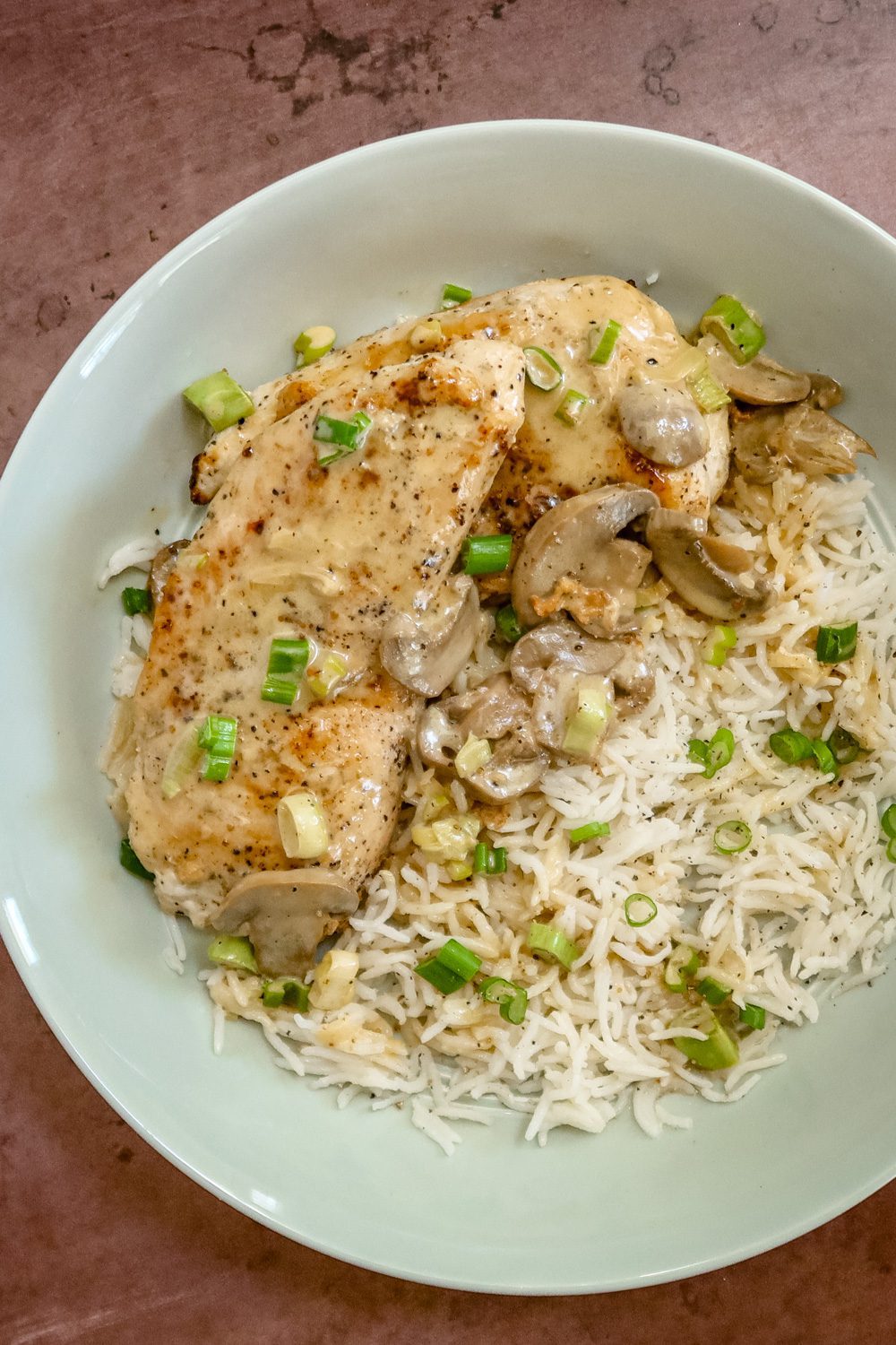 apple brandy chicken on a bed of rice with mushrooms and green onions