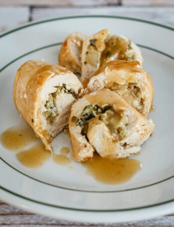Stuffed chicken breasts with apples and gravy, plated.