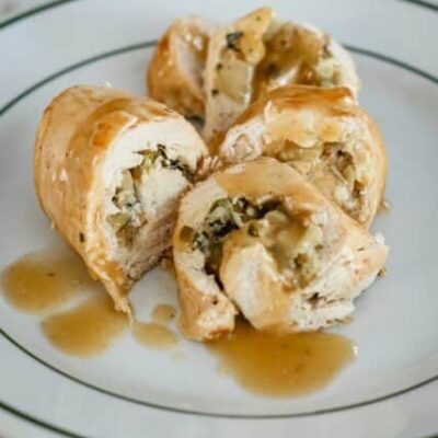 Stuffed chicken breasts with apples and gravy, plated.