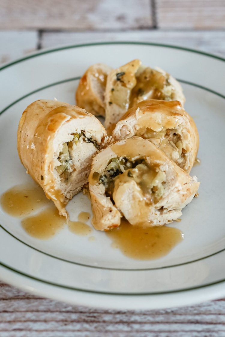 Stuffed chicken breasts with apples and gravy, plated.
