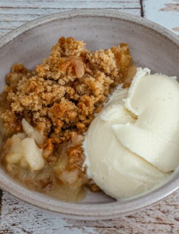 an apple crumble dessert with ice cream on the side