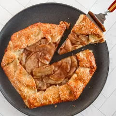 Golden apple galette with a flaky crust and caramelized apple filling.