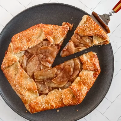 Golden apple galette with a flaky crust and caramelized apple filling.