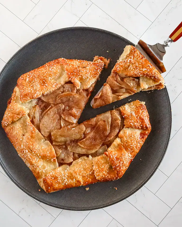 Golden apple galette with a flaky crust and caramelized apple filling.