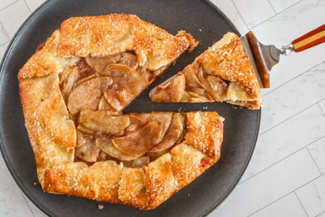 an apple galette with a slice cut out of it