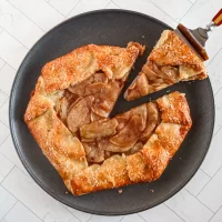 Rustic apple galette with golden crust and caramelized fruit.