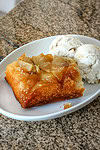 Warm apple cobbler with a crispy crust and sweet caramelized filling, served with a side of vanilla ice cream.
