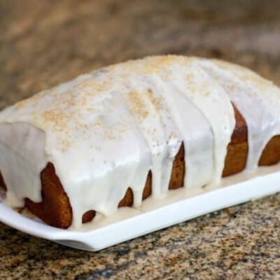 applesauce cake glazed and garnished with demerara sugar.