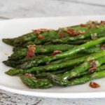 asparagus with bacon on a small platter