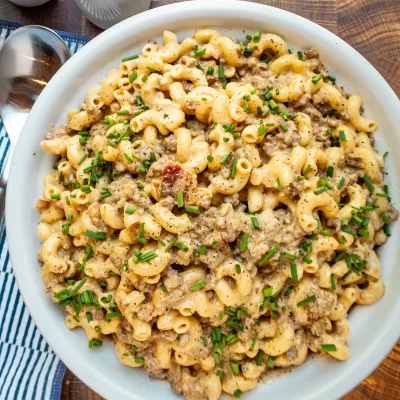Creamy ground beef and macaroni casserole garnished with chopped chives.