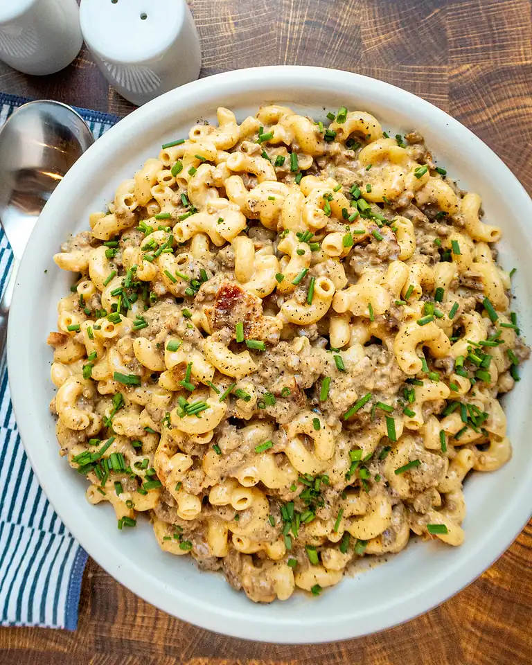 Creamy ground beef and macaroni casserole garnished with chopped chives.