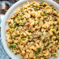 Beef and cheese mixture combined with the cooked macaroni in a serving dish with chives for garnish.