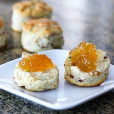 Bacon and chive biscuits on a plate with jam
