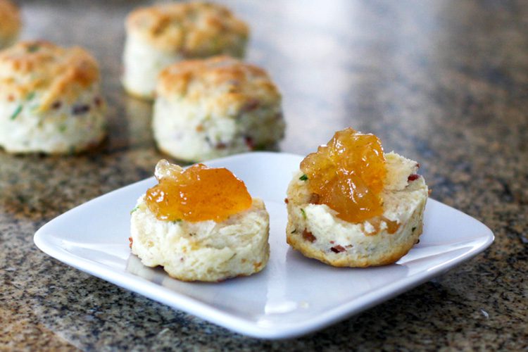 Bacon and chive biscuits on a plate with jam