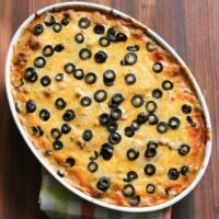 Creamy baked cheese pizza with black olives on top.