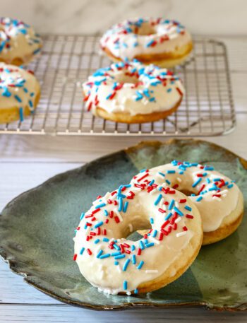 donuts with vanilla glaze and sprinkles on a plate