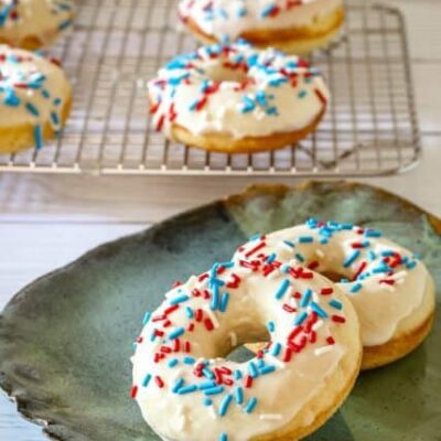 donuts with vanilla glaze and sprinkles on a plate