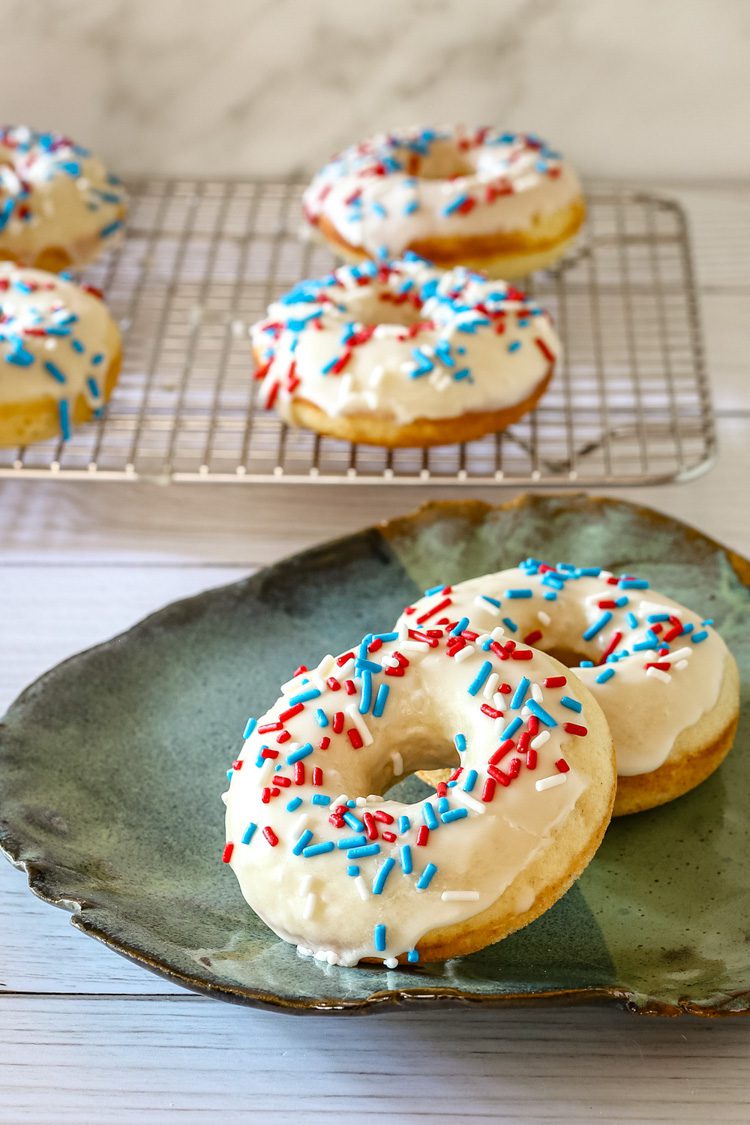 donuts with vanilla glaze and sprinkles on a plate