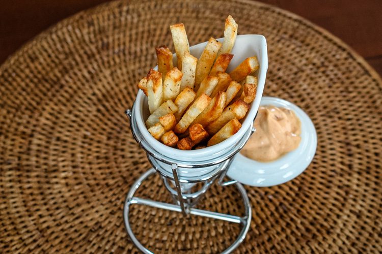 baked fries in a porcelain french fry cup