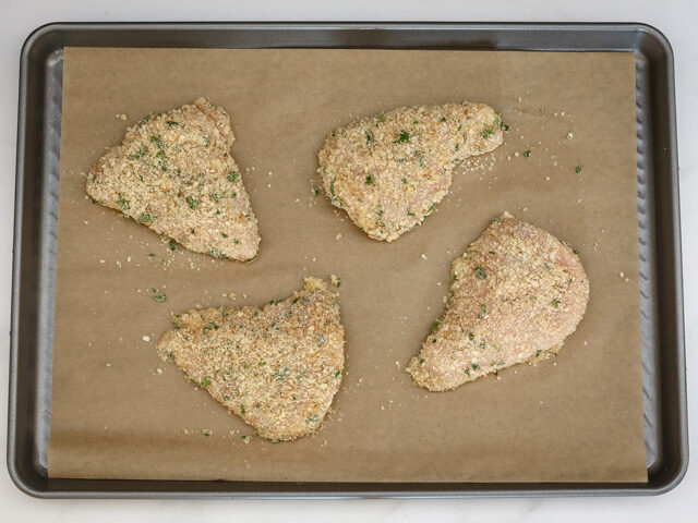 Chicken breasts on a baking sheet.