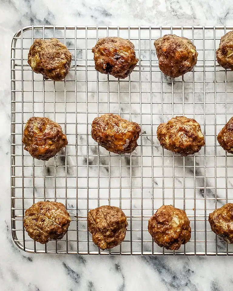 Meatballs on a wire rack.