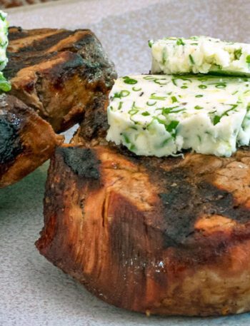 herb butter on grilled beef steaks