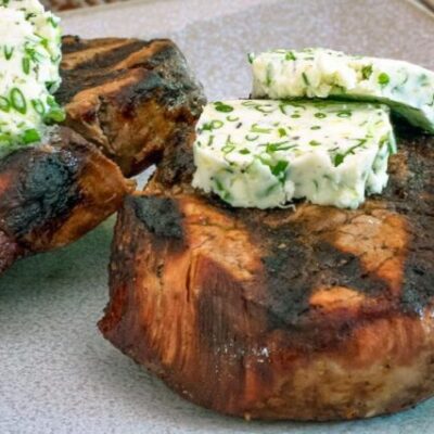 herb butter on grilled beef steaks